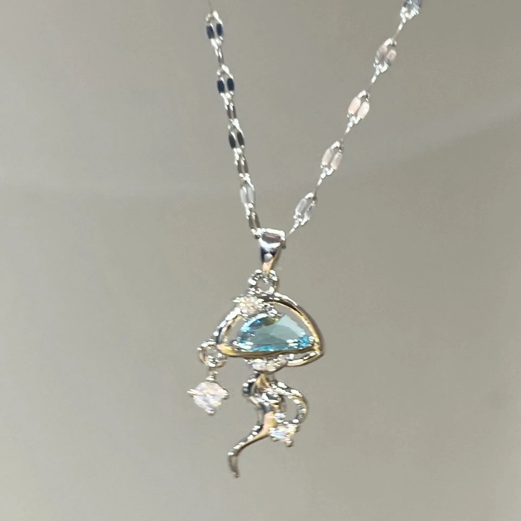 Blue jellyfish pendant on a white gold coloured adjustable sterling silver necklace chain.