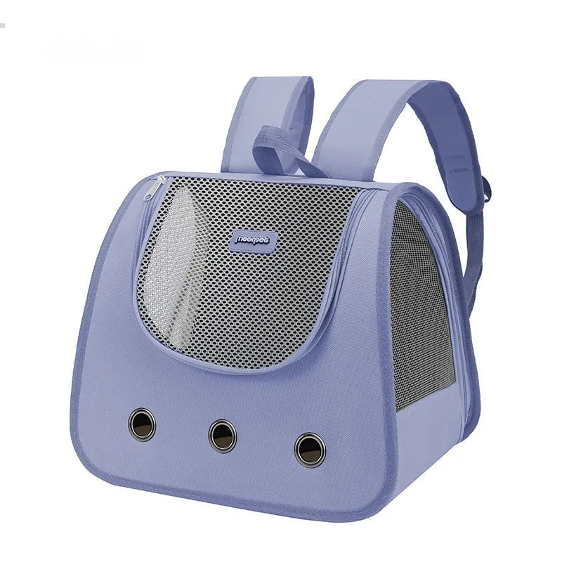 Solid colour Oxford cloth pet backpack for cats shown in light blue, worn on a person's back.