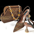 Women's pointed toe high heel shoe and small clutch bag set with rhinestone detail on a wine glass heel.