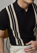 Men's black polo shirt with knitted collar and short sleeves laid flat.