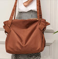 Women's black expandable shoulder crossbody bag made from Oxford cloth for travel and daily use.