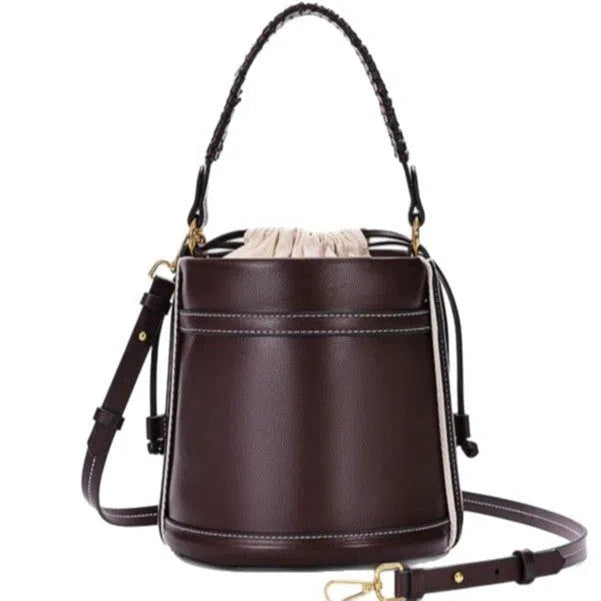 Brown PU cylindrical tote bag with dual handles and woven decorative stitching lines.