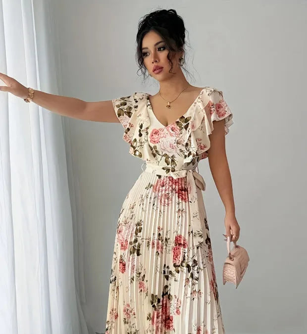 Apricot coloured floral print V-neck dress with ruffled sleeves and a pleated swing skirt.