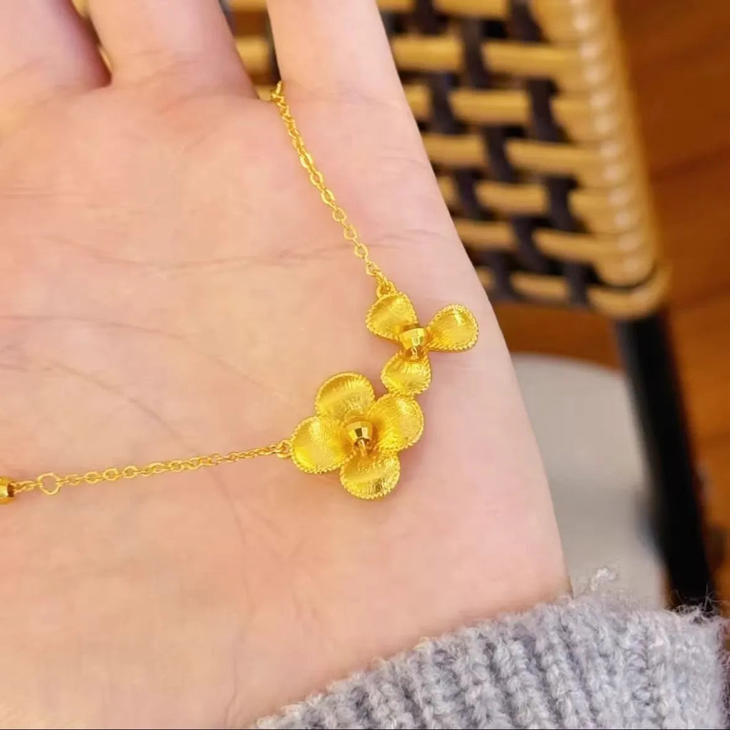 Gold plated brass flower necklace with bright floral pendant on adjustable clavicle chain