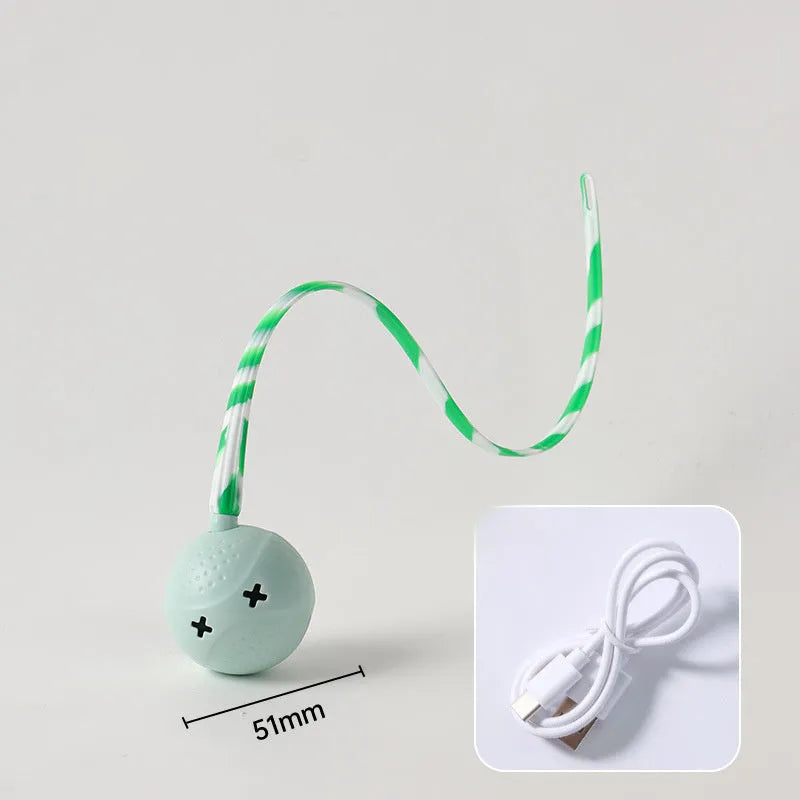 Green electric wagging tail cat ball toy on floor with motion sensor for interactive play