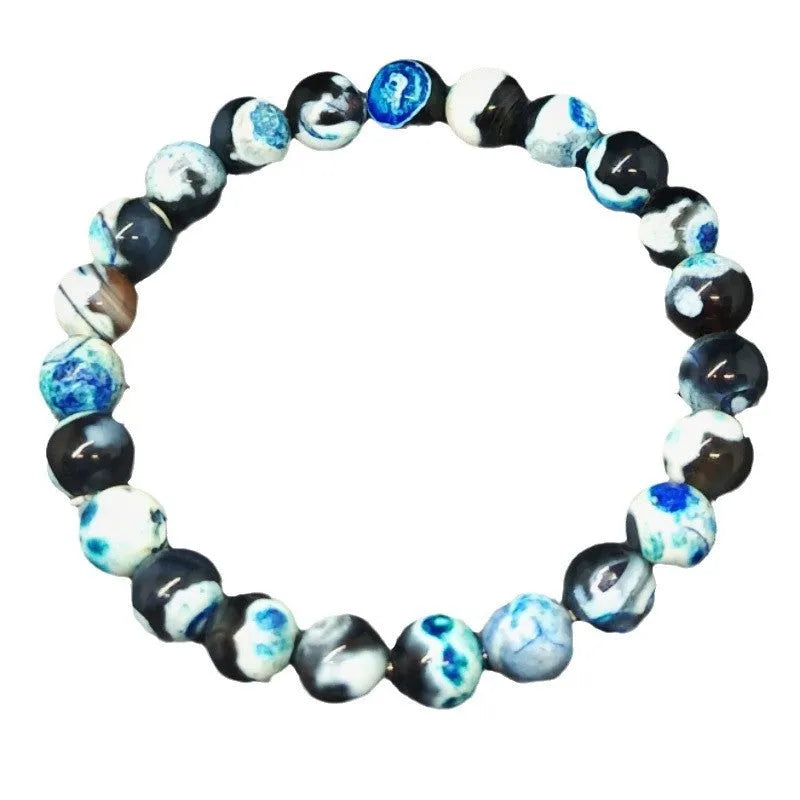 Handmade bohemian bracelet with natural agate and coloured glass beads on a wrist.