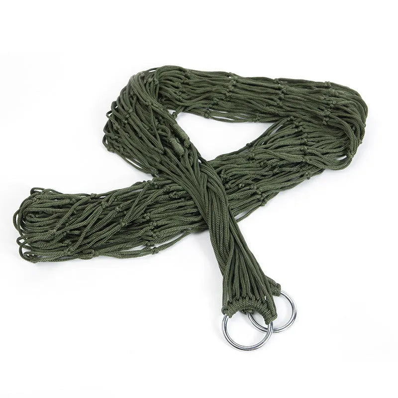 Outdoor Supplies 9-strand nylon rope hammock in red hanging between trees in a garden