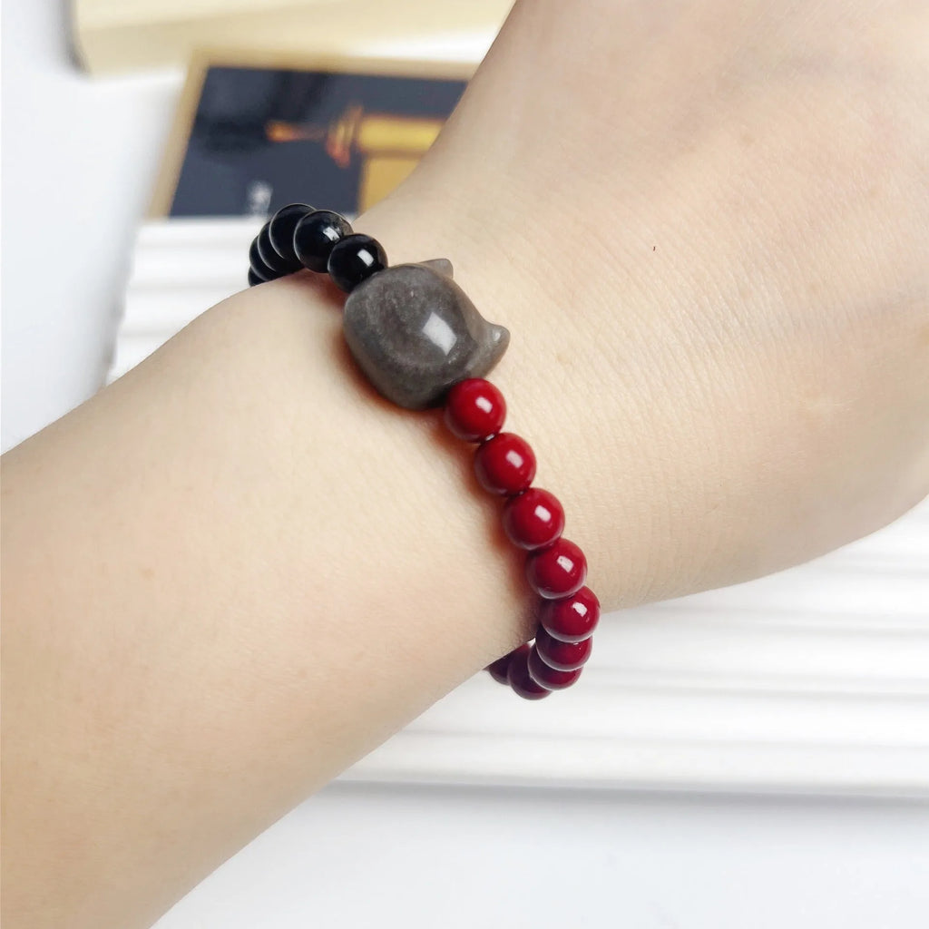 Handmade black obsidian bracelet with cat charm and colourful beads on elastic cord with adjustable ties.
