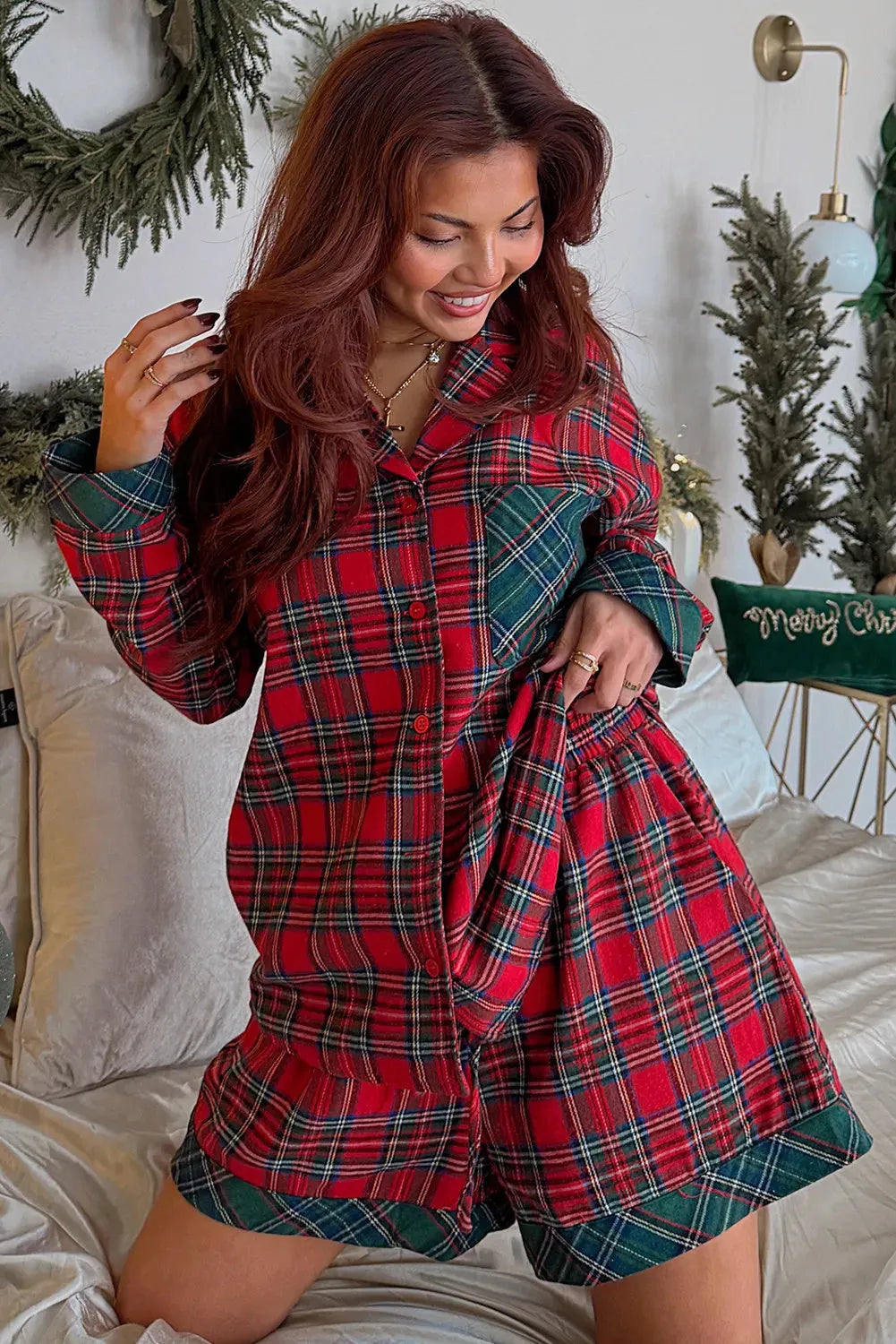 Red plaid Christmas pyjama set for adults, featuring a long sleeve shirt and shorts with contrast patches.