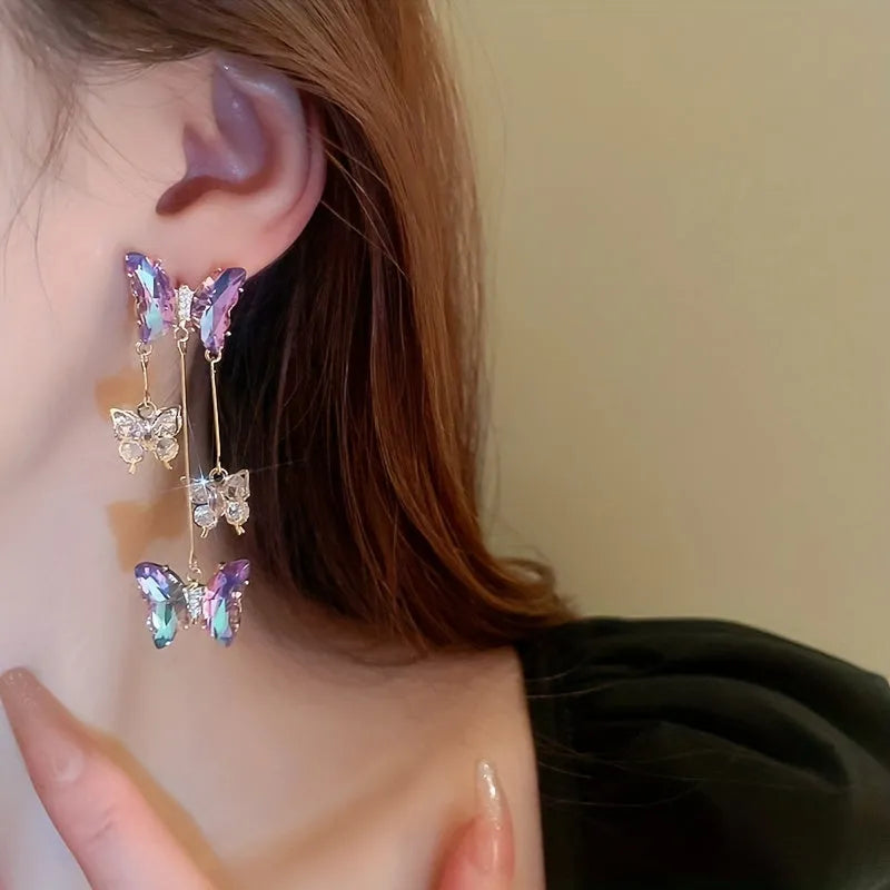 A pair of women's silver-plated alloy tassel drop earrings with crystal flowers in a blue purple butterfly colour.