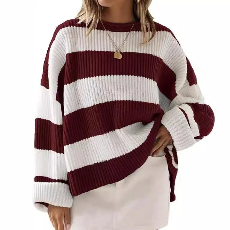 Women's loose striped sweater with long bell sleeves and white crocheted flower decoration on the front.
