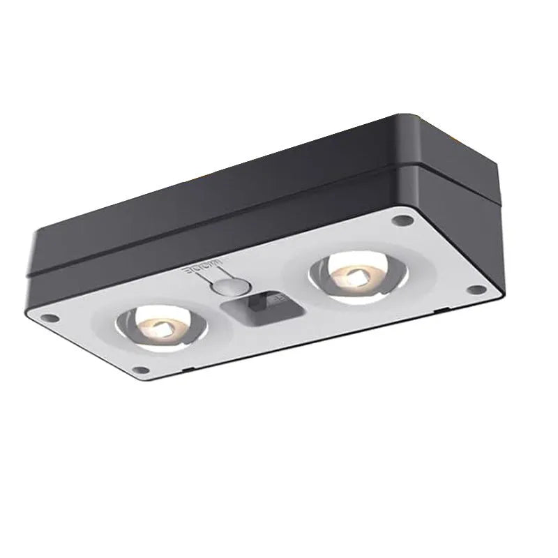 Black solar LED fence light with colourful fixed lens, IP55 rated, 105mm, mounted on a wooden fence