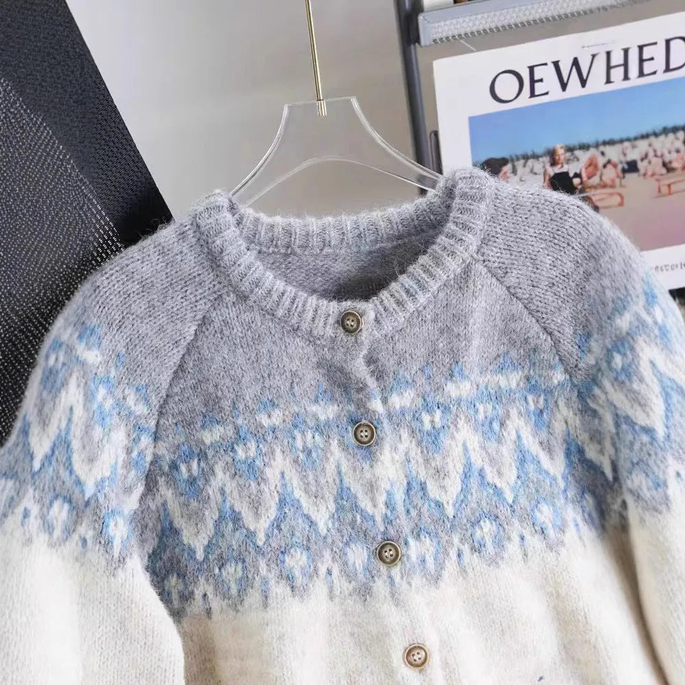 Women's loose beige jacquard knit coat sweater with long sleeves on a hanger