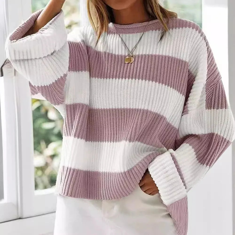 Women's loose striped sweater with long bell sleeves and white crocheted flower decoration on the front.