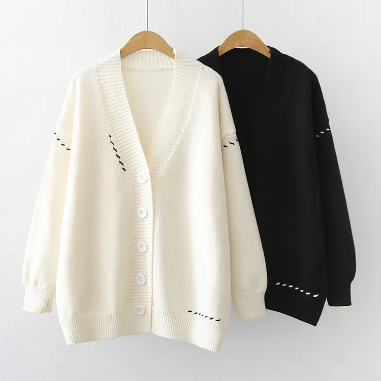 Women's loose fit long sleeve knitted cardigan coat in black or white.