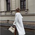 White thick-knit women's cardigan jacket with long sleeves, shown open as a loose-fitting layer.
