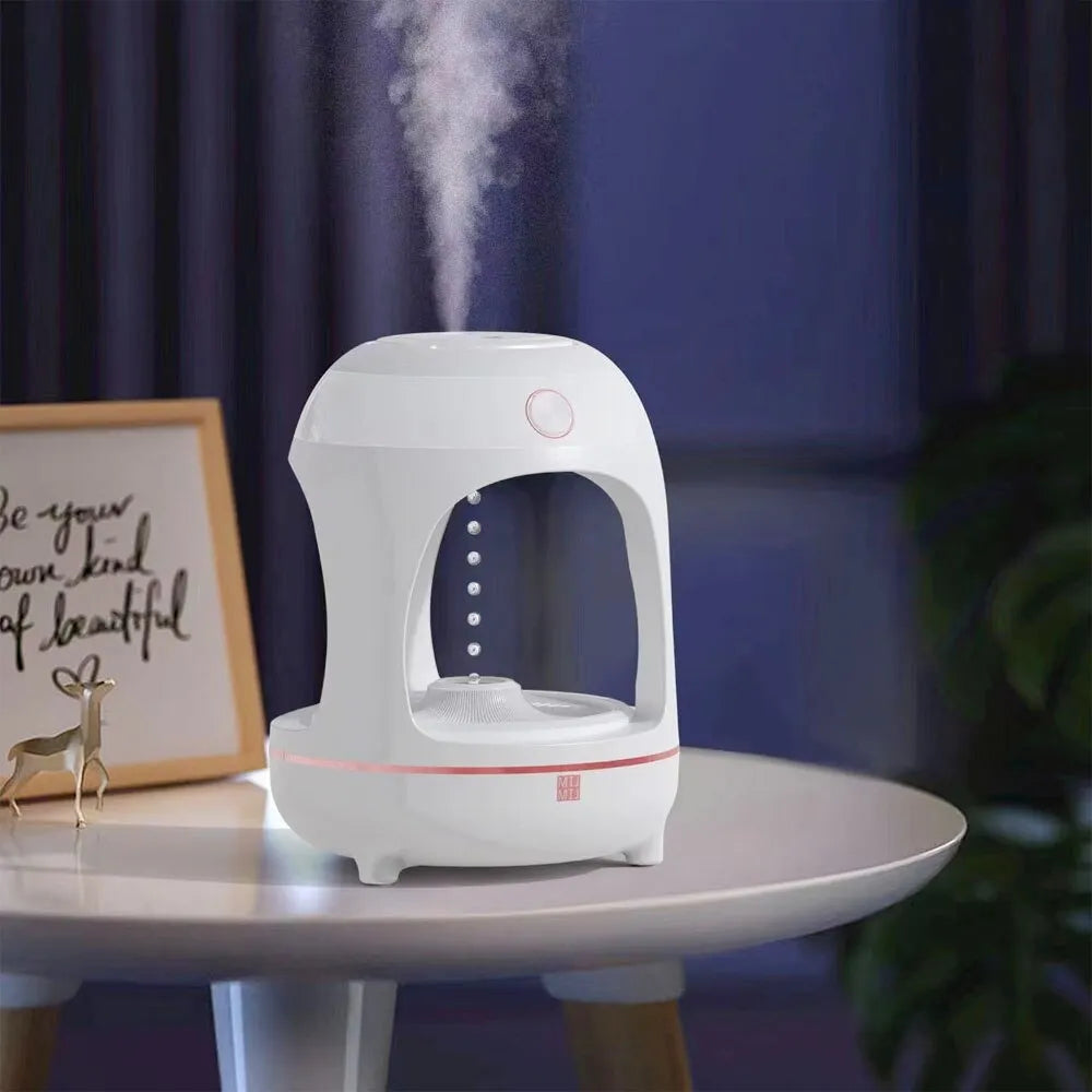 Rose gold and white columnar humidifier with levitating water drops and LED glow on a desk