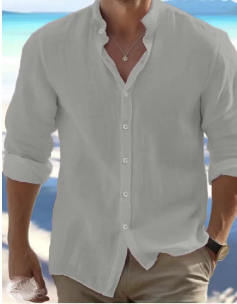 Man wearing a light blue long-staple cotton pullover summer shirt with casual collage stitching details.