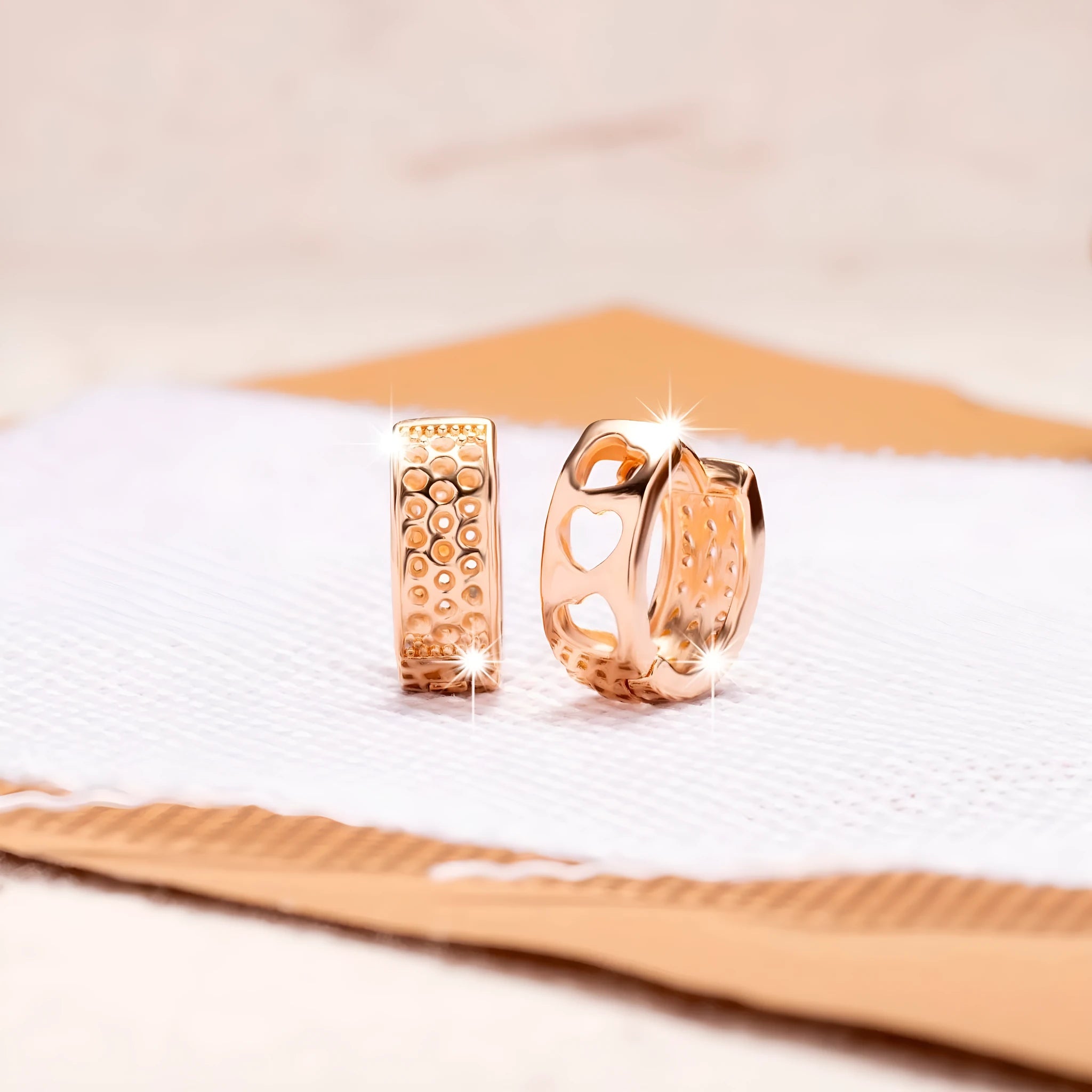 Rose gold women's earrings with a hollowed out heart shape and circular frame.