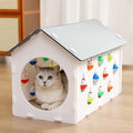 Plastic cat scratch board integrated with a nest, a bell ball, and a tunnel for pet play and rest.