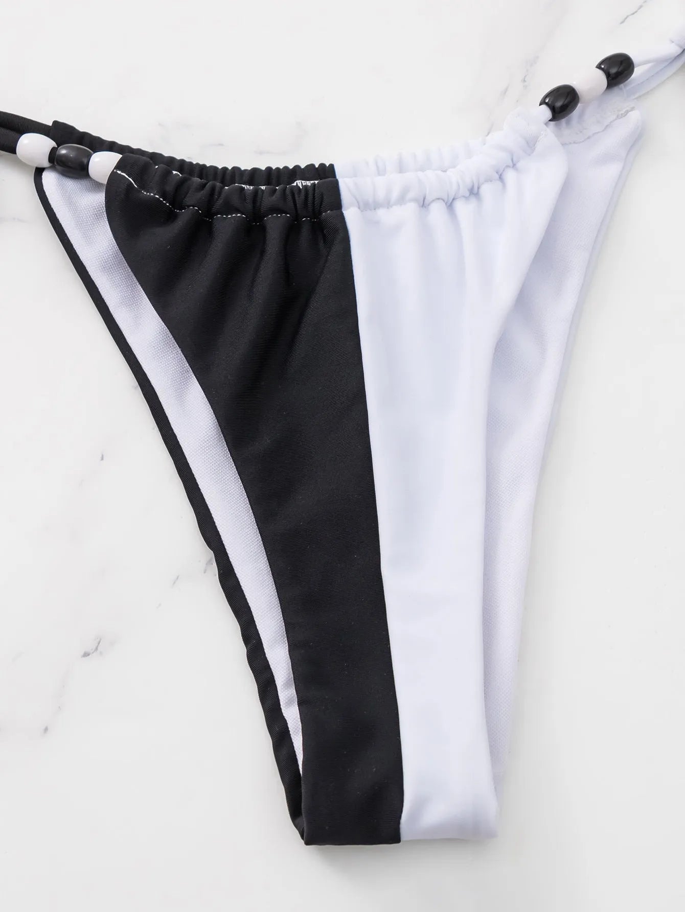 Black and white women's lace-up triangle cup bikini swimsuit with briefs-style bottom