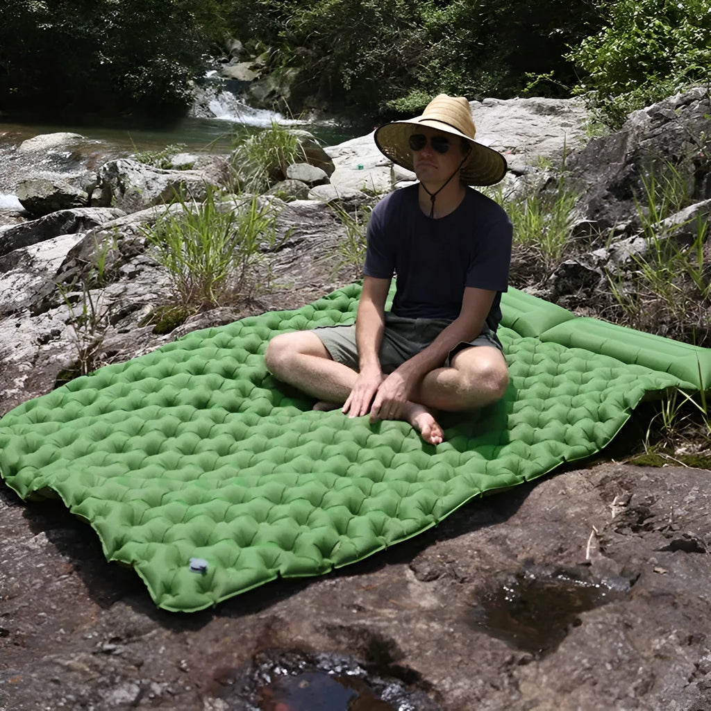 Double-wide camping air mattress with integrated pillow in army green colour, shown inflated.