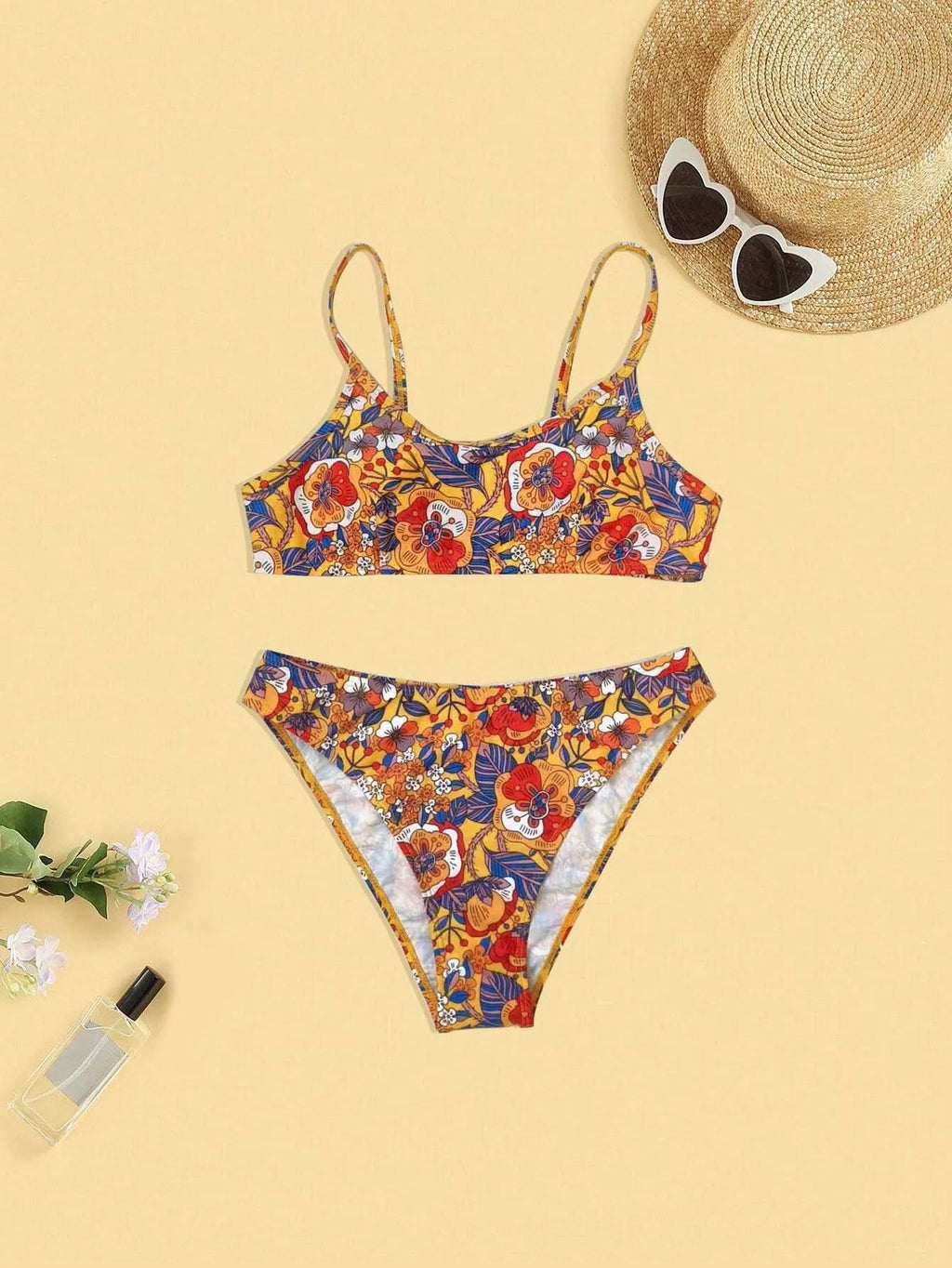 Plus size women's floral print bikini swimsuit with strap design on white background