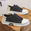 Men's blue canvas casual shoes with round toe and lace-up front, showing PVC sole detail