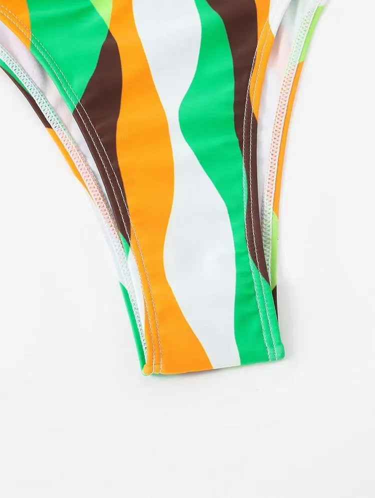 Yellow green women's three-piece bikini set with printed skirt on a hanger.