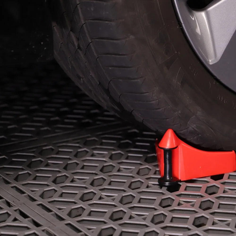 Four red plastic triangular parking blocks for car tyre stopping and vehicle positioning