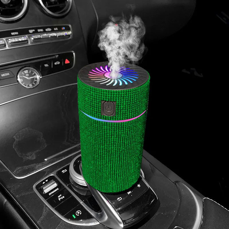 Compact white diamond car air humidifier on a car dashboard with USB cable.