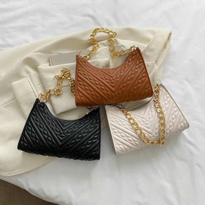 Brown pleated chain strap baguette shoulder bag showing vertical square shape and soft handle.