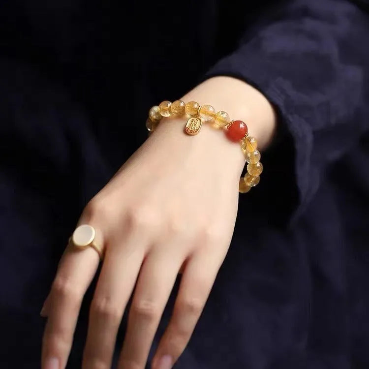 Red agate lucky bead bracelet with gold ruby accents showing polished natural stone beads