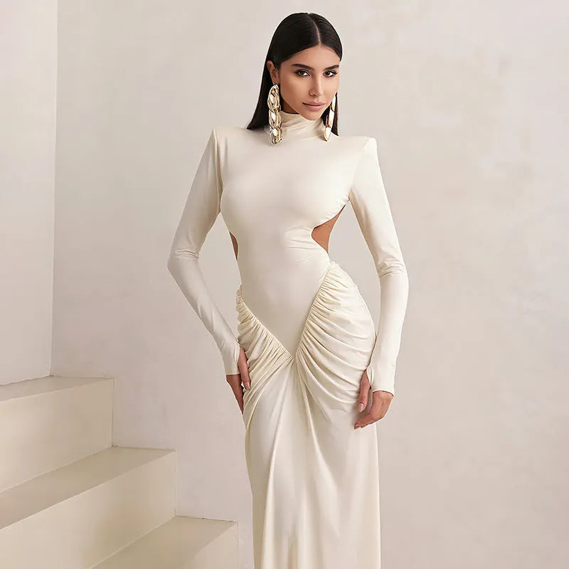 Women's light apricot high collar long sleeve pleated backless slim fit dress on a model.