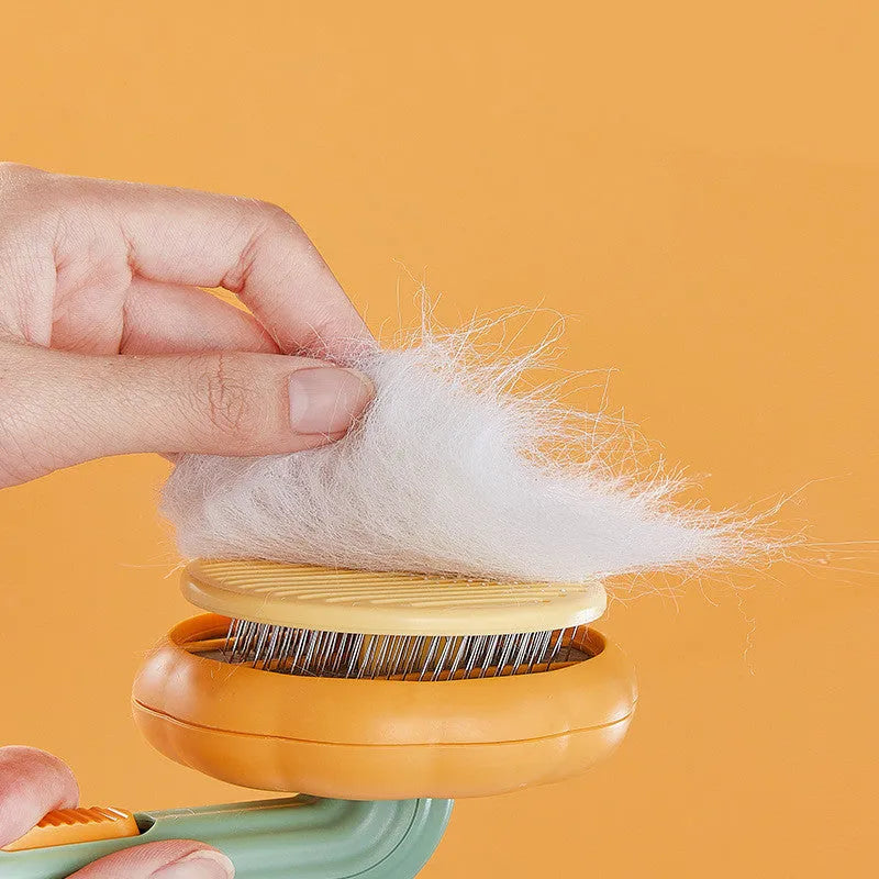 Pumpkin coloured pet grooming brush with curved stainless steel needles for hair removal