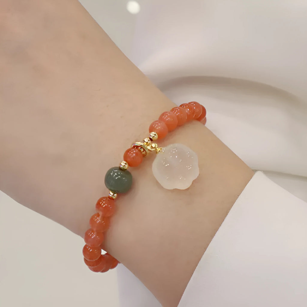Polished red agate and green jade women's bracelet with a cat's paw charm.