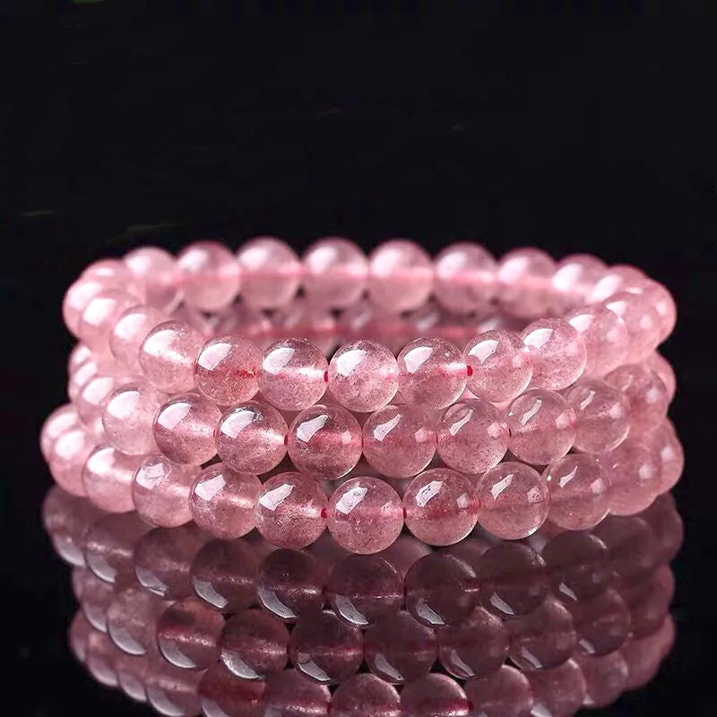 Women's strawberry quartz crystal bracelet showing polished natural stones in 6mm, 8mm or 10mm bead sizes