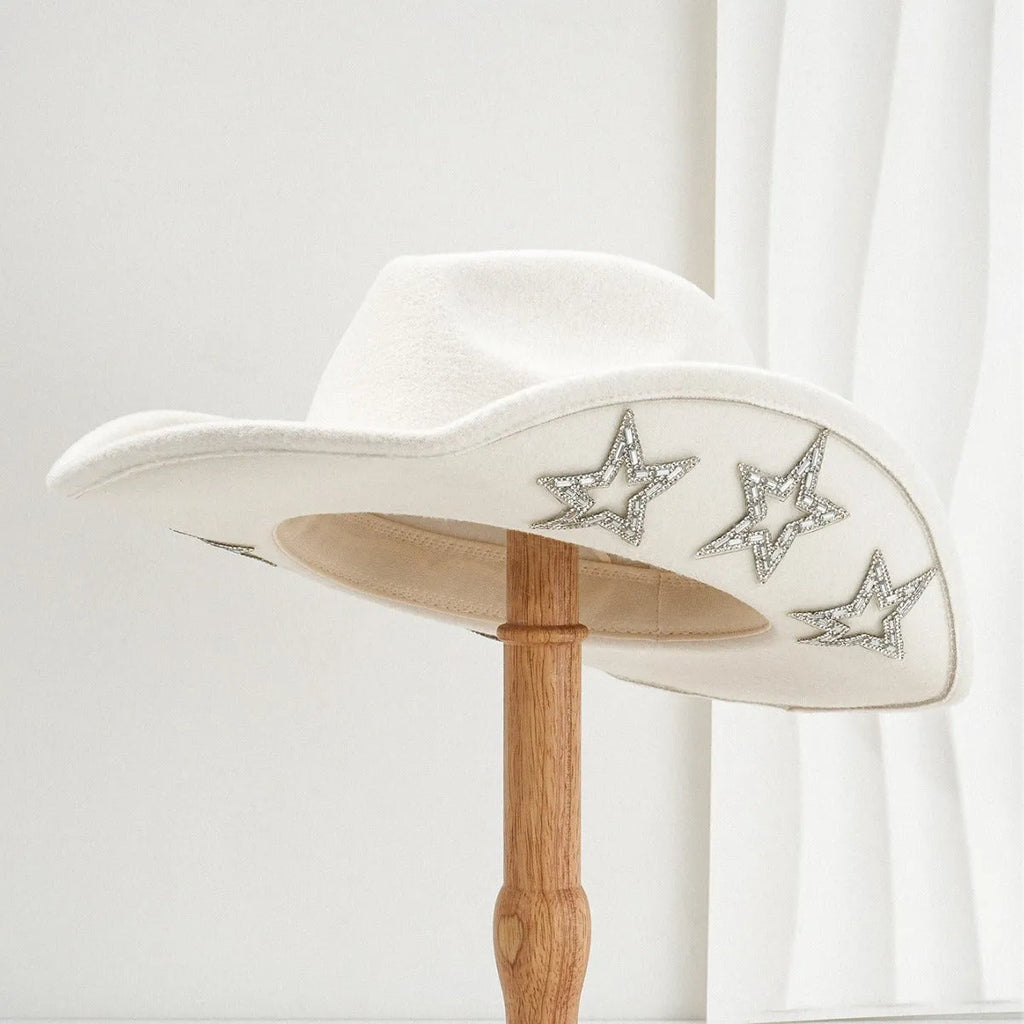 Beige woolen felt Western-style top hat with a conical crown and a silver hexagonal star decoration on the front.