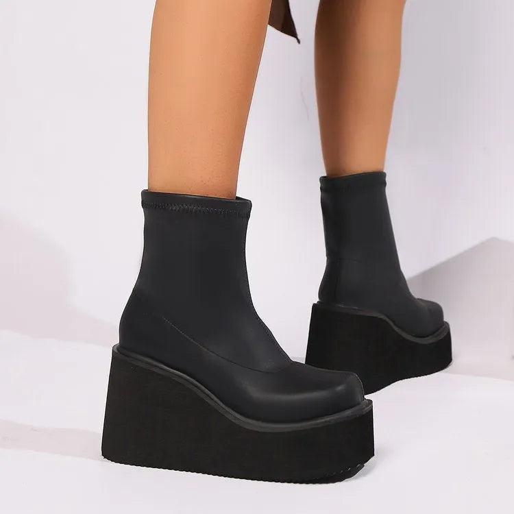 Plus size women's black wedge heel ankle boots with a waterproof platform and round toe.