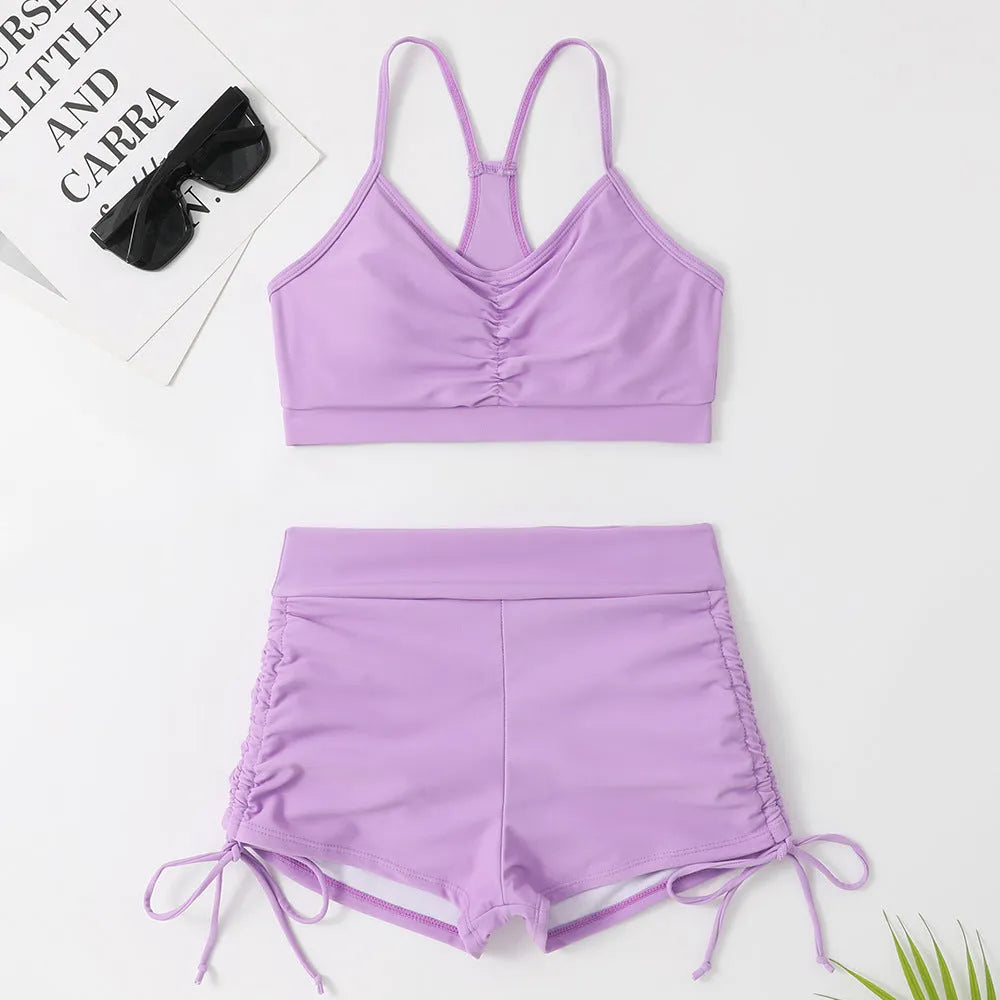 Women's high-waisted split bikini swimsuit in black or violet colour.