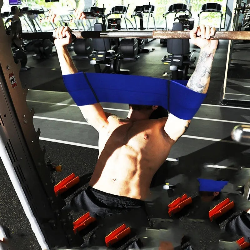 Black elastic elbow support bandage wrapped around an adult arm during a fitness training session.