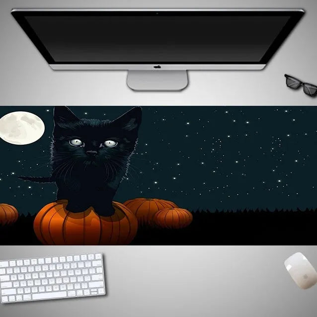 Oversized Halloween themed gaming mouse pad with non-slip rubber cloth base on a desk