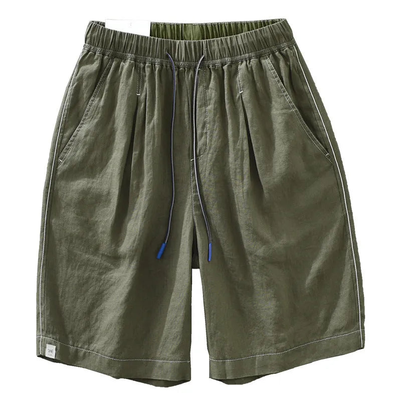 Men's loose straight fit linen shorts in green with drawstring waist, shown laid flat
