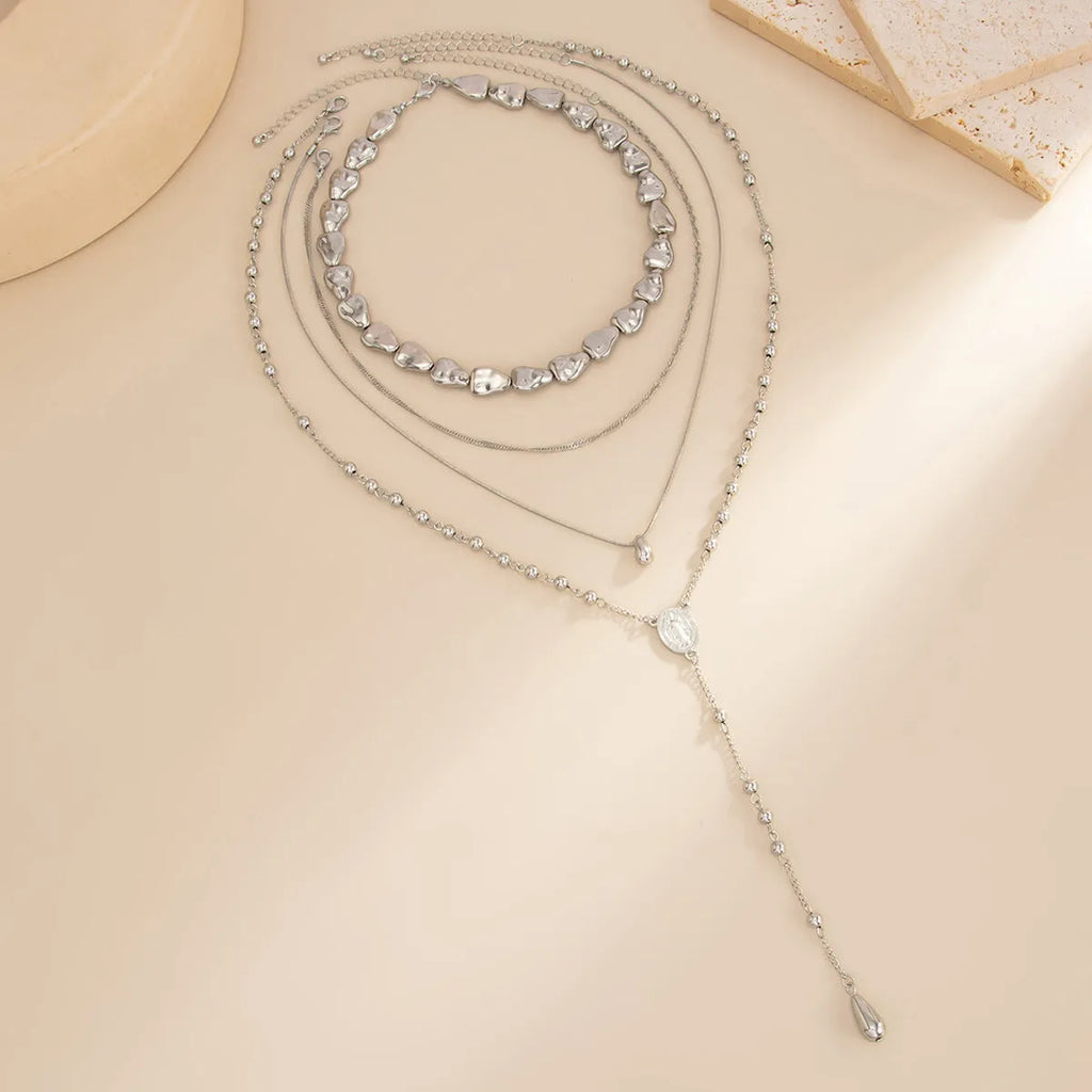 Irregular shaped CCB beaded long necklace in gold set 6836 on display showing geometric alloy pendant and adjustable chain