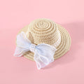 Pink pearl bow straw hat for a cat on a mannequin head, showing Lafite leaf weave and butterfly detail.