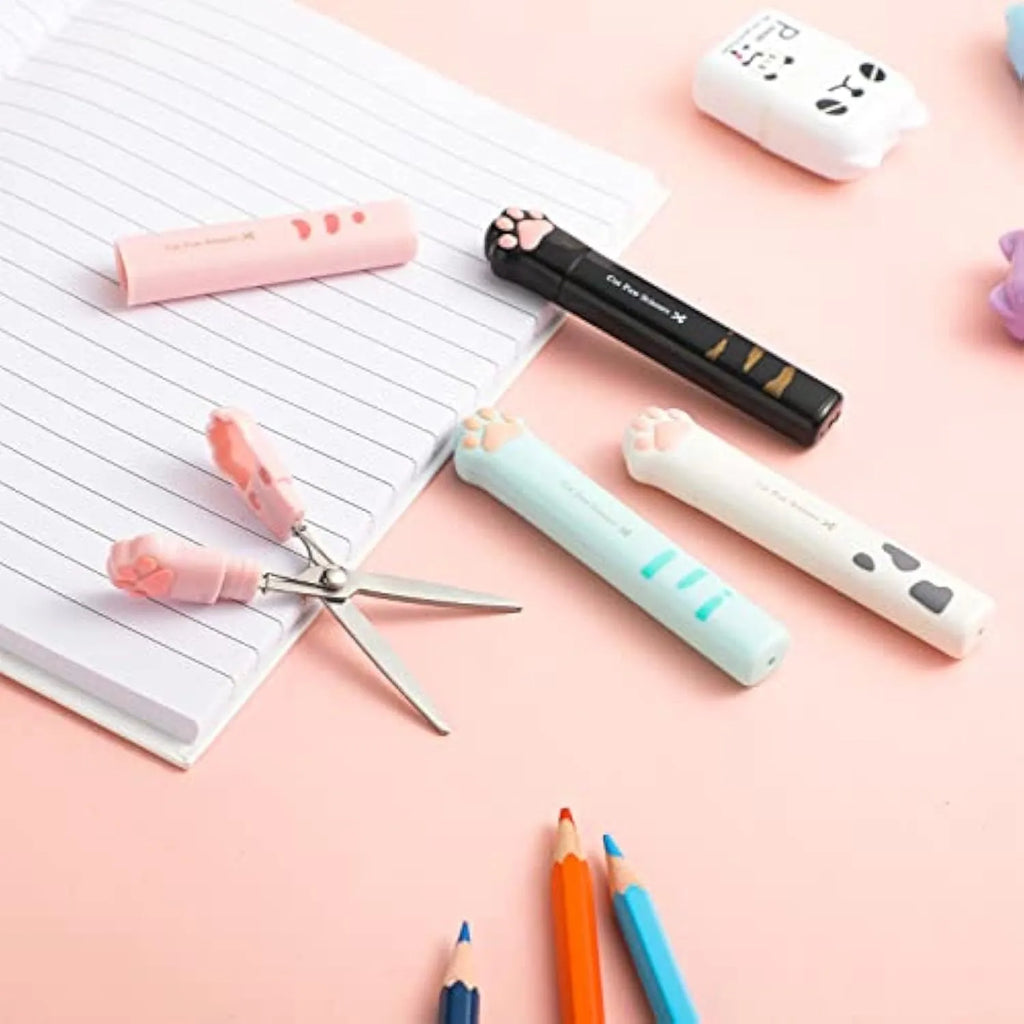 Set of four colourful mini folding scissors with cat paw handles on a white background.