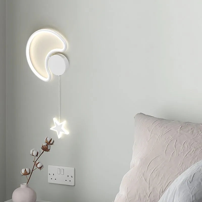 White cloud-shaped children's wall lamp with LED light mounted beside a bed.