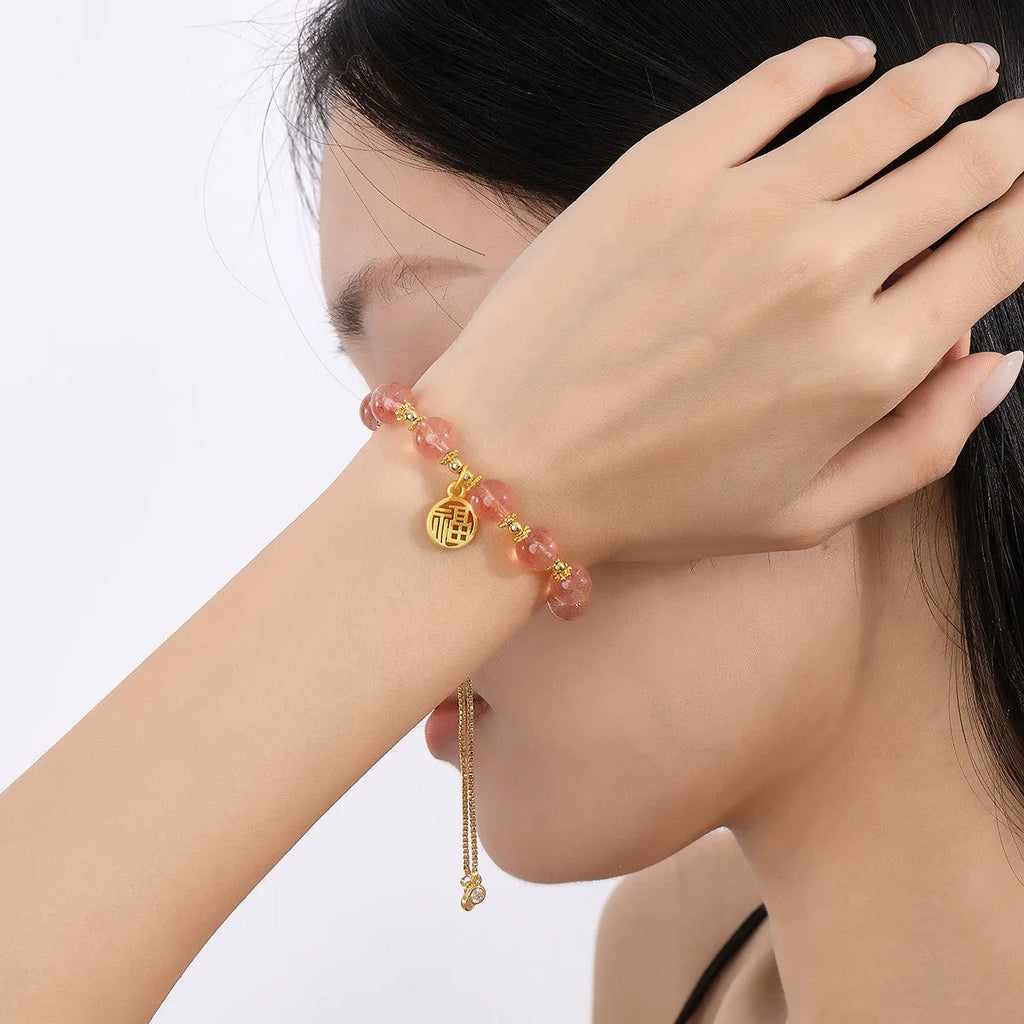 Strawberry quartz electroplated crystal bracelet with geometric fu charm