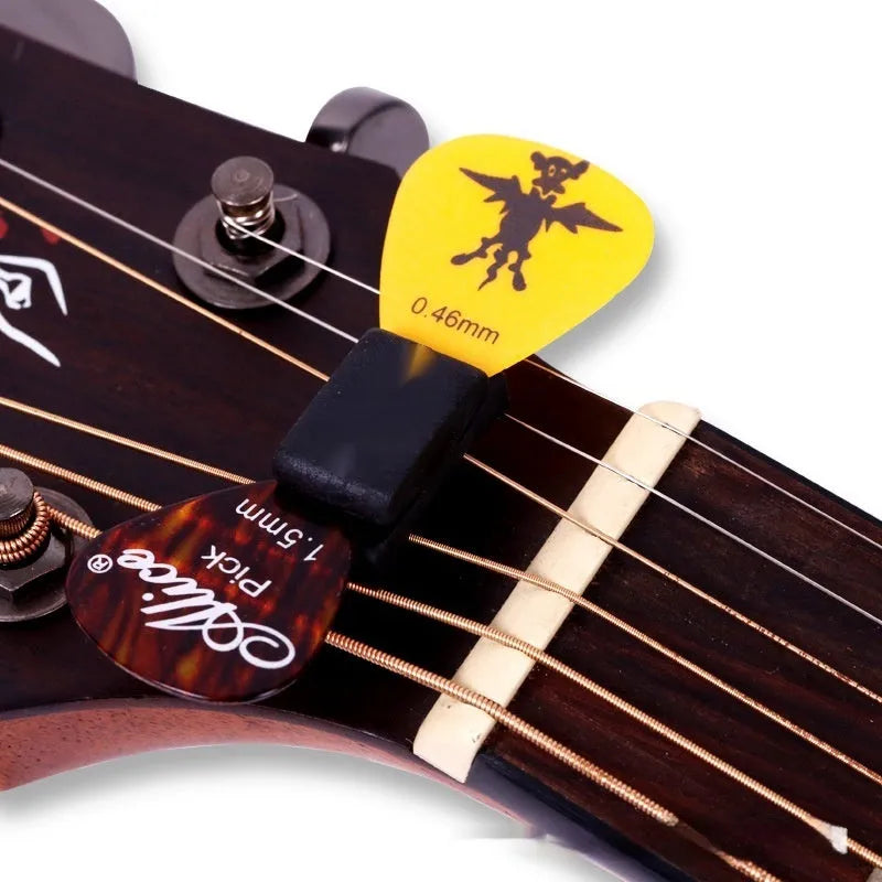 Black rubber guitar plectrum holder 2.5cm by 1cm on headstock for plectrum storage