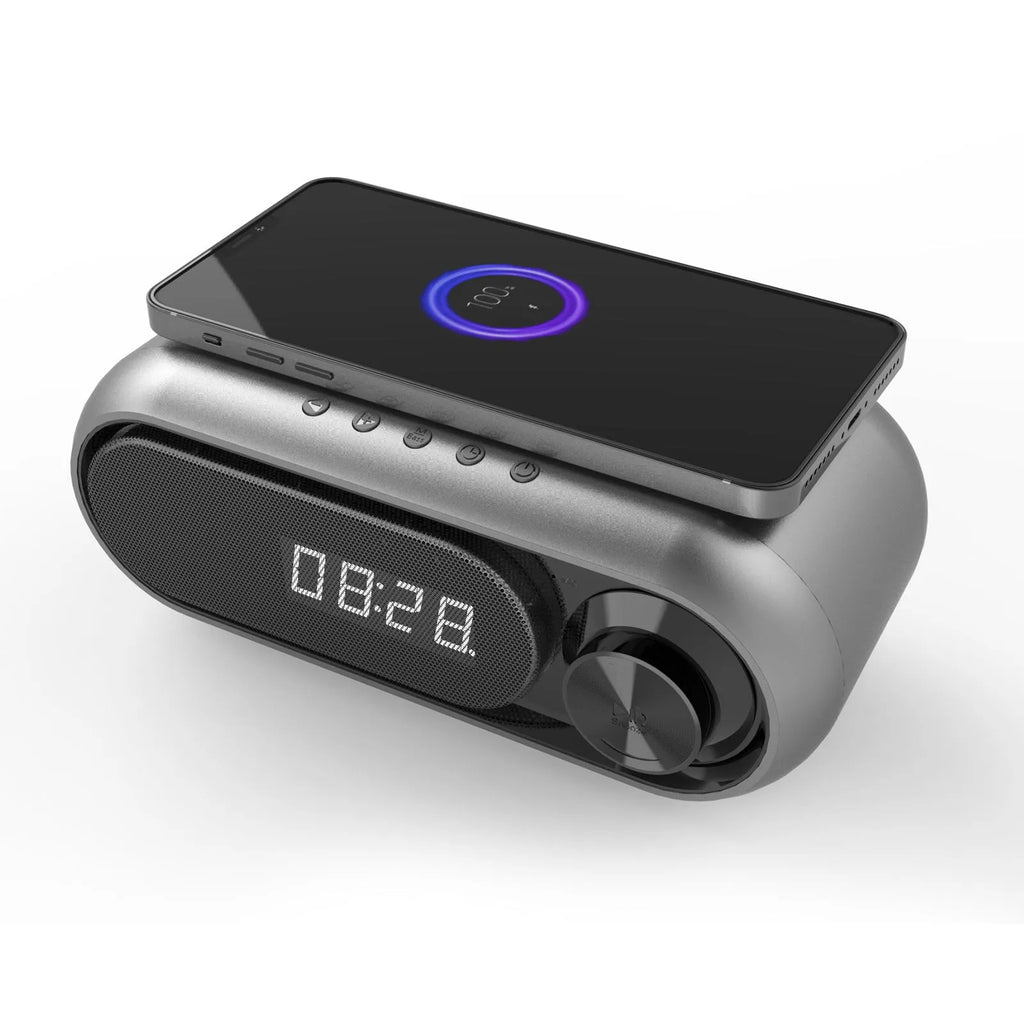Wireless charging bedside alarm clock with LED display in space grey colour showing time and charging smartphone
